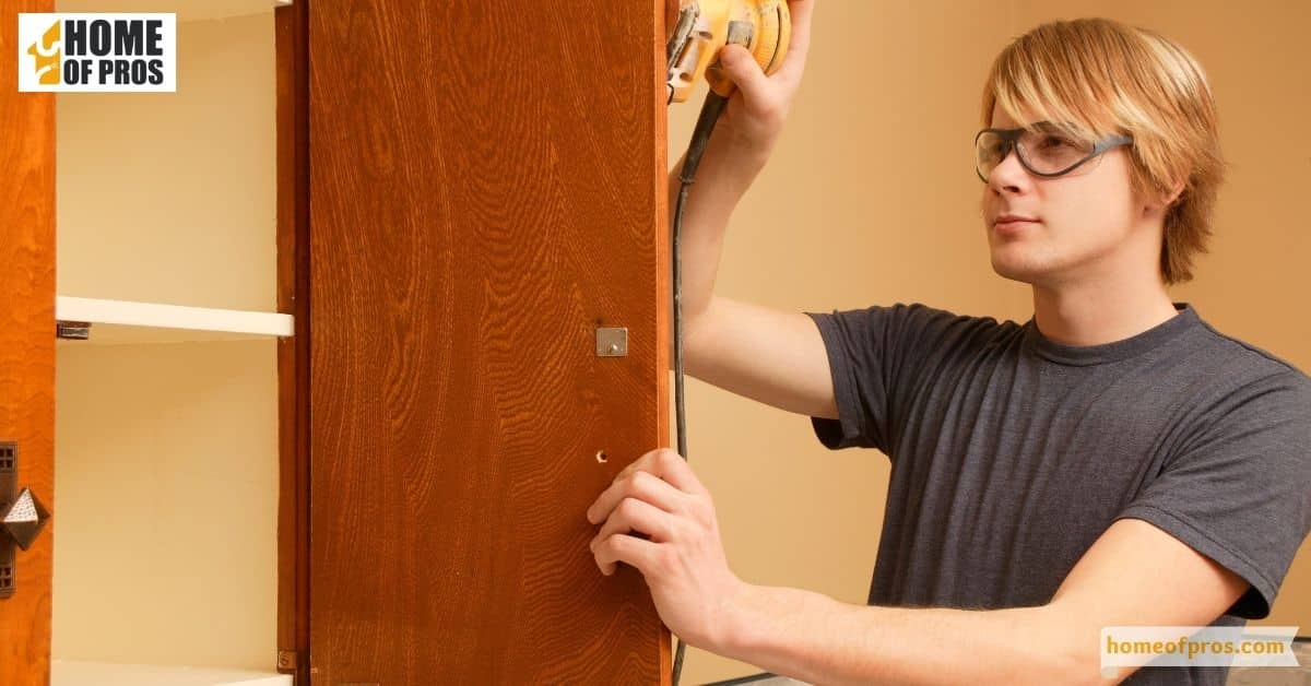 Sand the cabinets to create a smooth surface for the paint